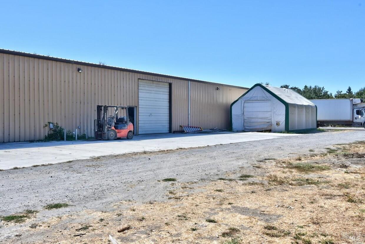 4770 Occidental Road Santa Rosa, CA 95401 - Photo 7 of 30 a front view of a house with a yard and garage