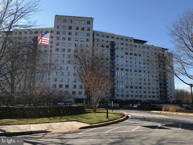 a sign board with buildings in the background