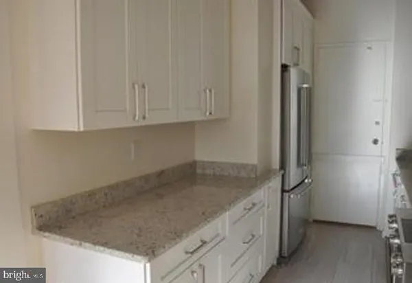 a kitchen with granite countertop a sink and cabinets