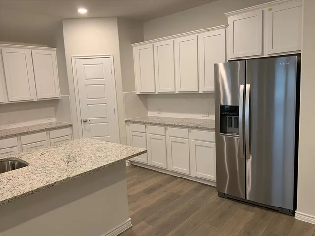 a kitchen with a refrigerator and a sink
