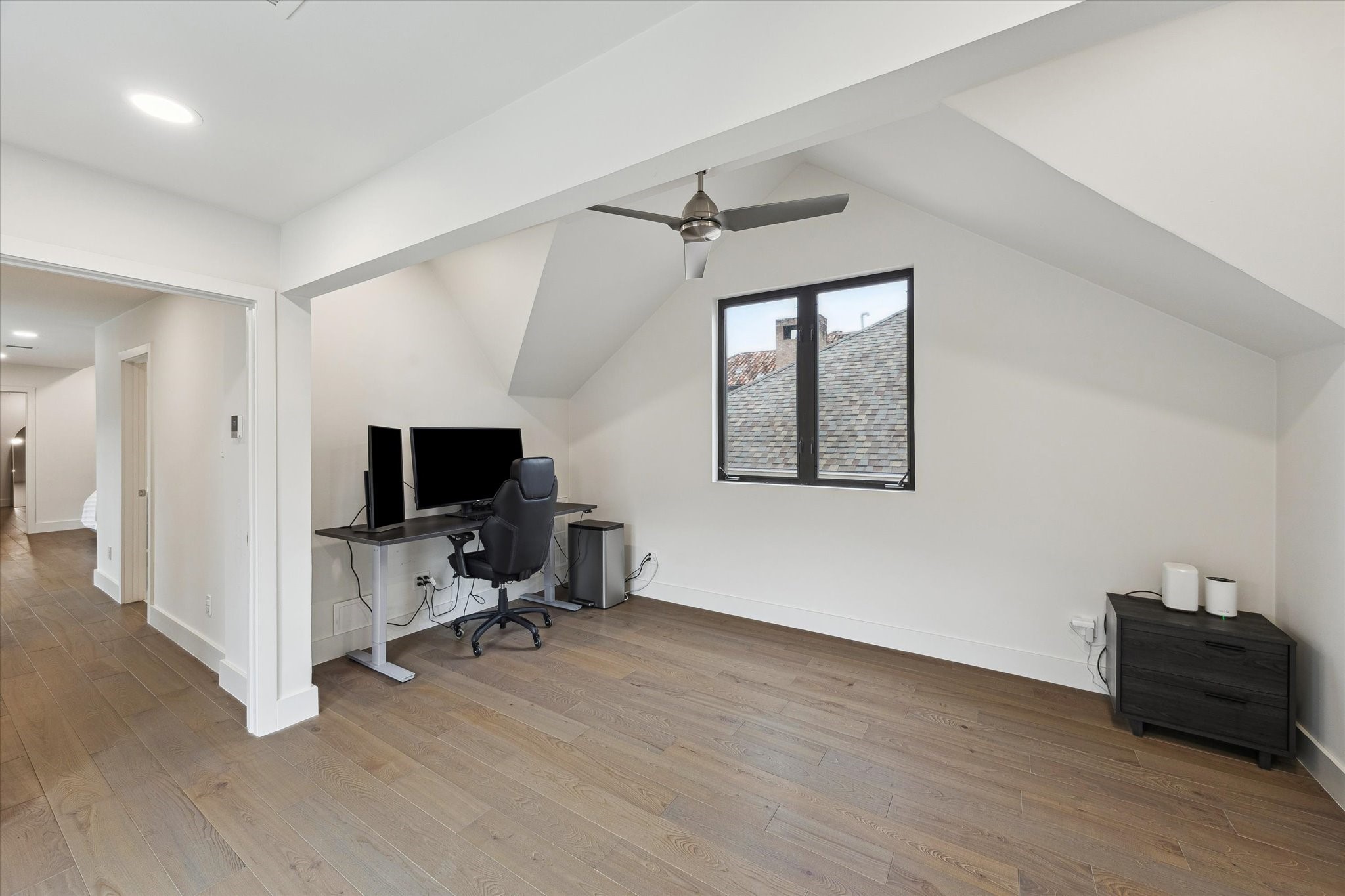 6348 Vanderbilt Street West University Place, TX 77005 - Photo 21 of 30 The second-floor flex space is one of this home's most versatile assets. Whether you envision a home office, a dedicated study, a playroom, or a workout studio, the vaulted ceiling, warm hardwood floors, and generous square footage make it work beautifully for whatever your lifestyle demands.