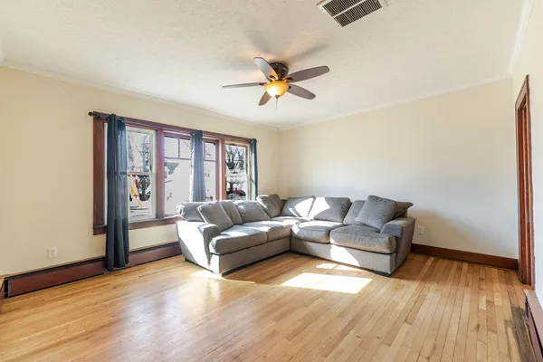 a living room with couches and a coffee table with wooden floor