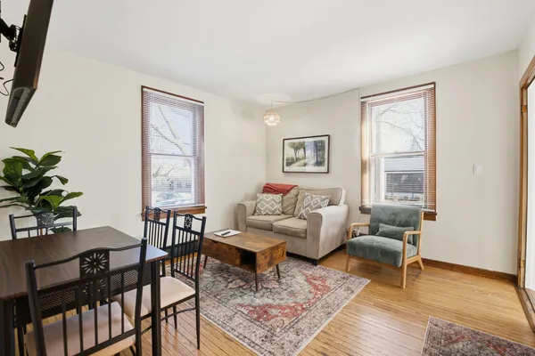 a living room with furniture and wooden floor