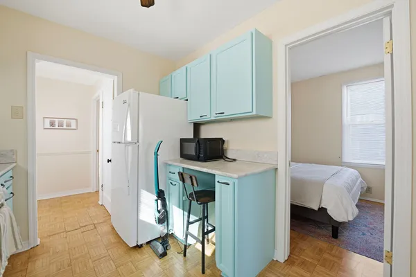 a kitchen with stainless steel appliances a refrigerator a sink a stove and white cabinets