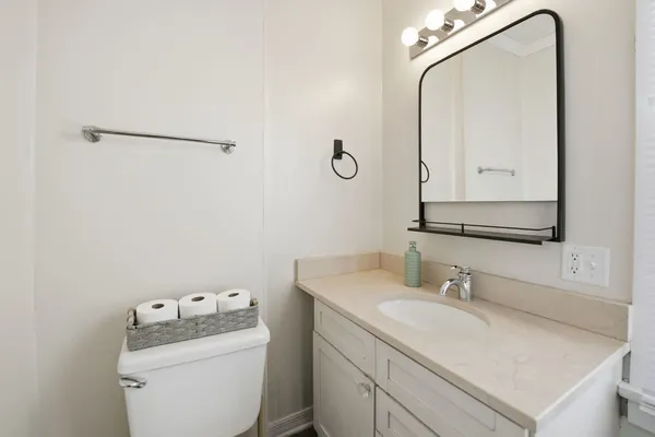 a bathroom with a sink vanity and a mirror