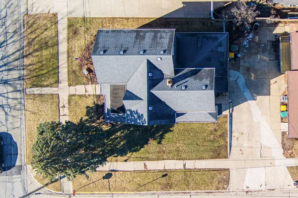 an aerial view of a house with a yard