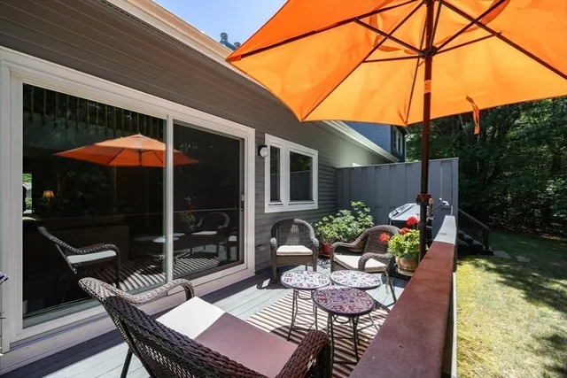 a view of a house with backyard sitting area and furniture