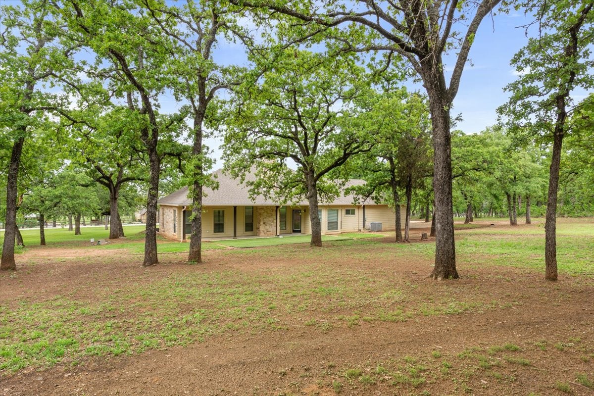140 Oak Ridge Loop Whitney, TX 76692 - Photo 37 of 40 a house with trees in front of it