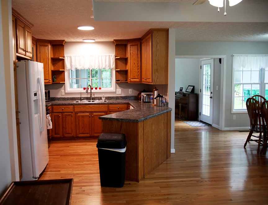 1047 Mooneyhan Road Springfield, TN 37172 - Photo 15 of 29 a kitchen with stainless steel appliances granite countertop a refrigerator a sink dishwasher a stove and a dining table with wooden floor