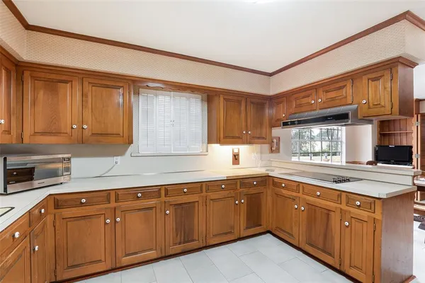 a kitchen with sink cabinets and window