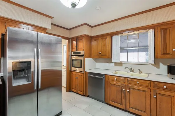 a kitchen with stainless steel appliances granite countertop a refrigerator and a sink