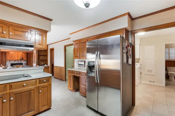 a kitchen with stainless steel appliances granite countertop a refrigerator and a sink