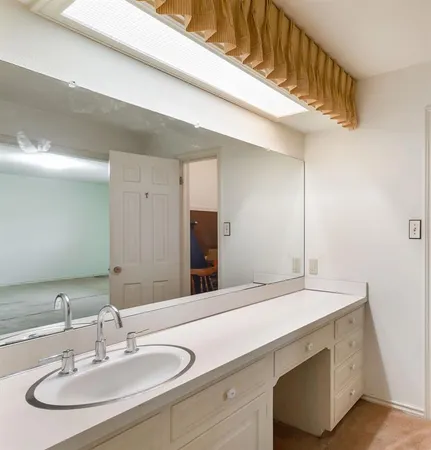 a bathroom with a sink and a mirror