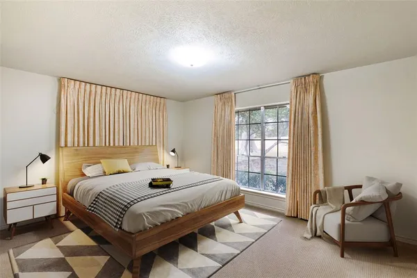 a bedroom with a bed and a window