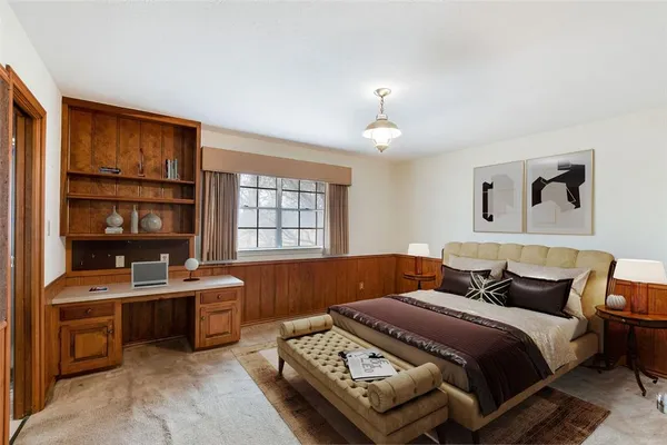 a bedroom with furniture and a window