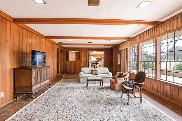 a living room with furniture fireplace and a flat screen tv