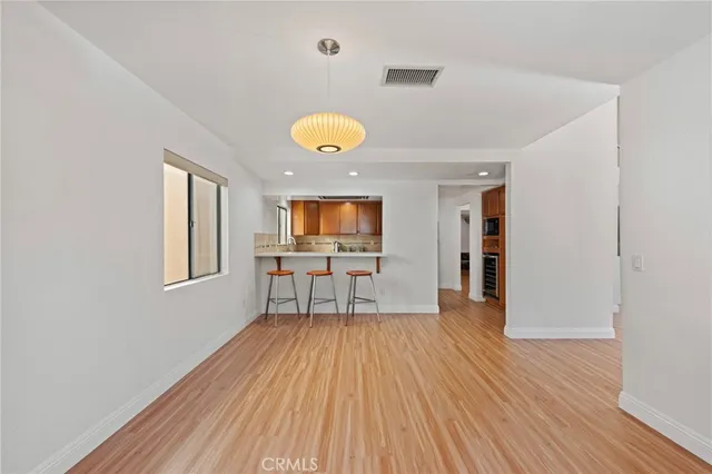 a view of a livingroom with wooden floor and a ceiling fan