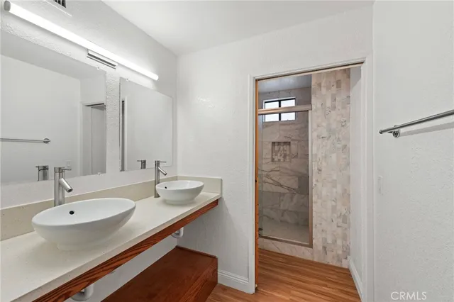 a bathroom with a sink a mirror and shower