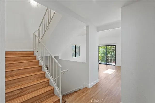 a view of entryway and hall with wooden floor