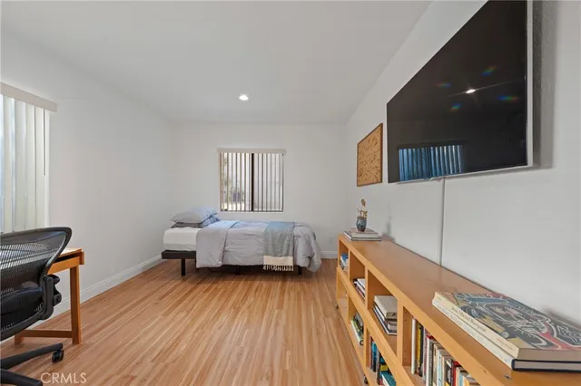 a spacious bedroom with a bed and a desk