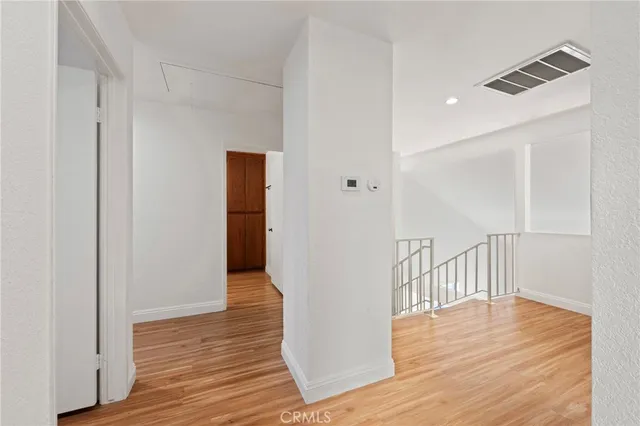 a view of hallway with wooden floor
