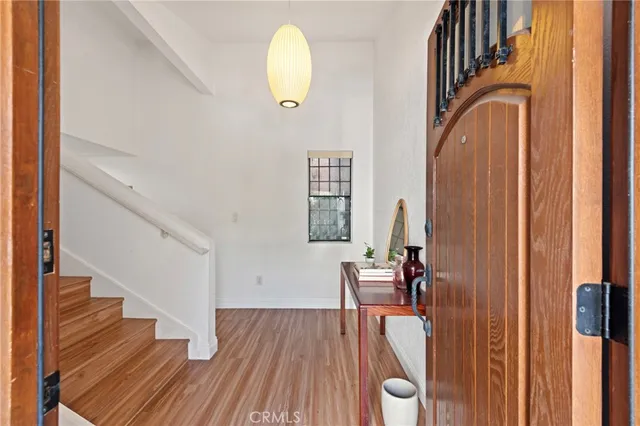 a view of a hallway with wooden floor and staircase