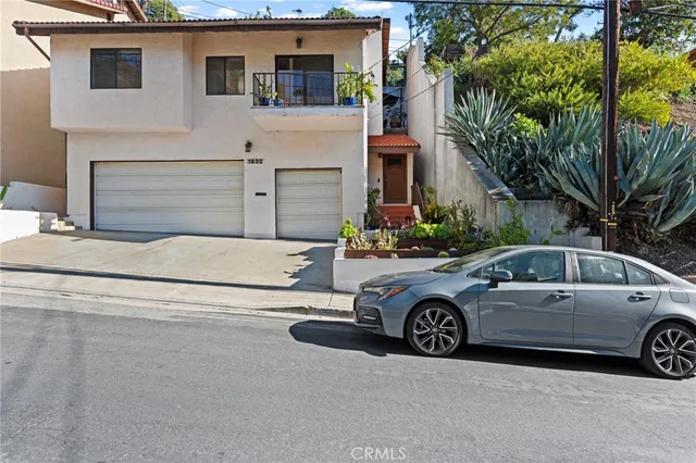 a view of a car parked in front of a house