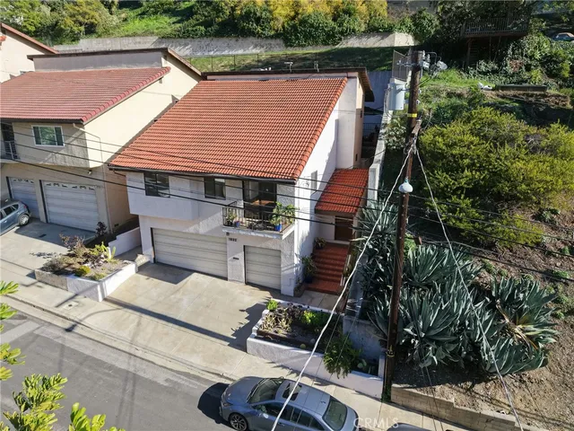 a view of a house with a yard and sitting area