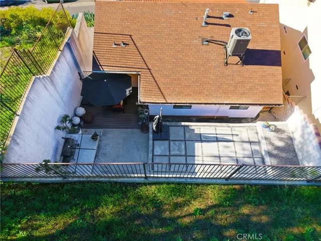 an aerial view of a house with a garden and swimming pool
