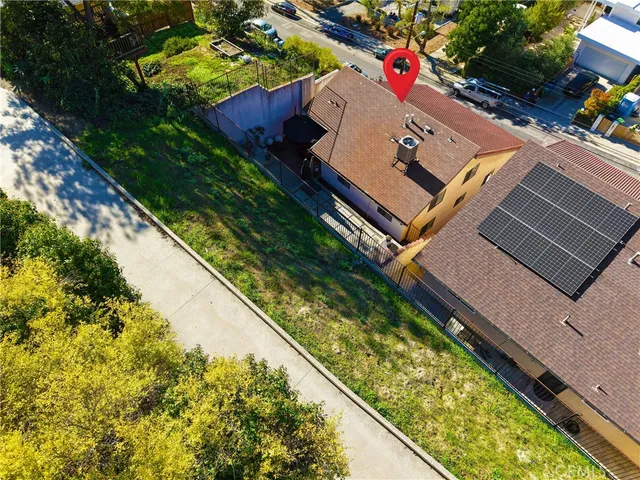 an aerial view of a houses with a lake