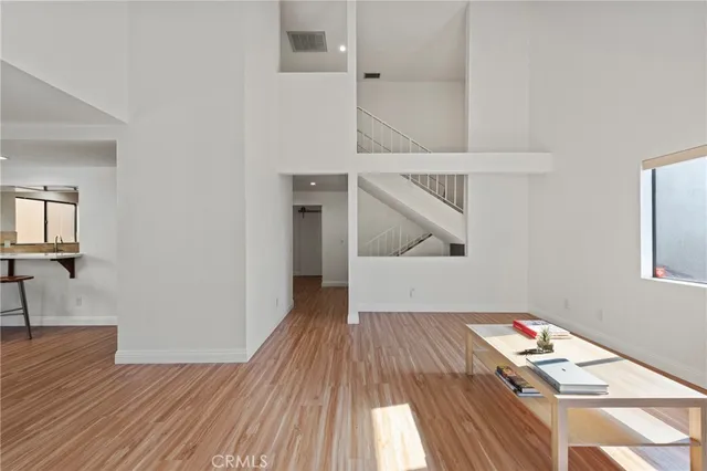 a room with wooden floor and entryway