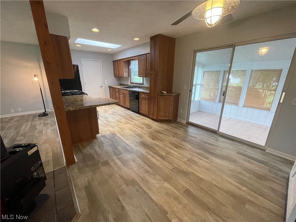 2345 Antioch Road Perry, OH 44081 - Photo 7 of 17 Kitchen with light hardwood floors and black dishwasher