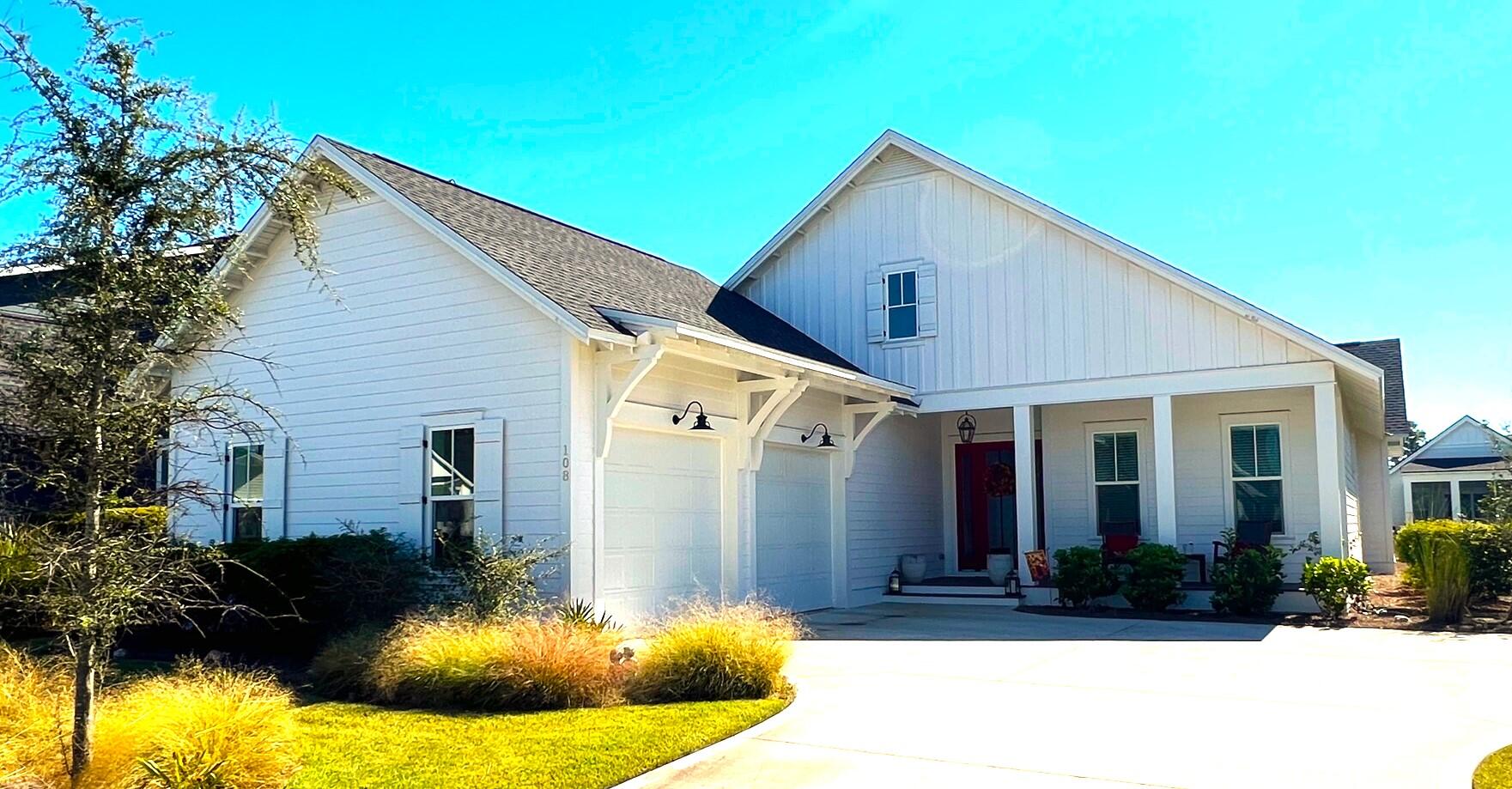 a view of a house with backyard and sitting area