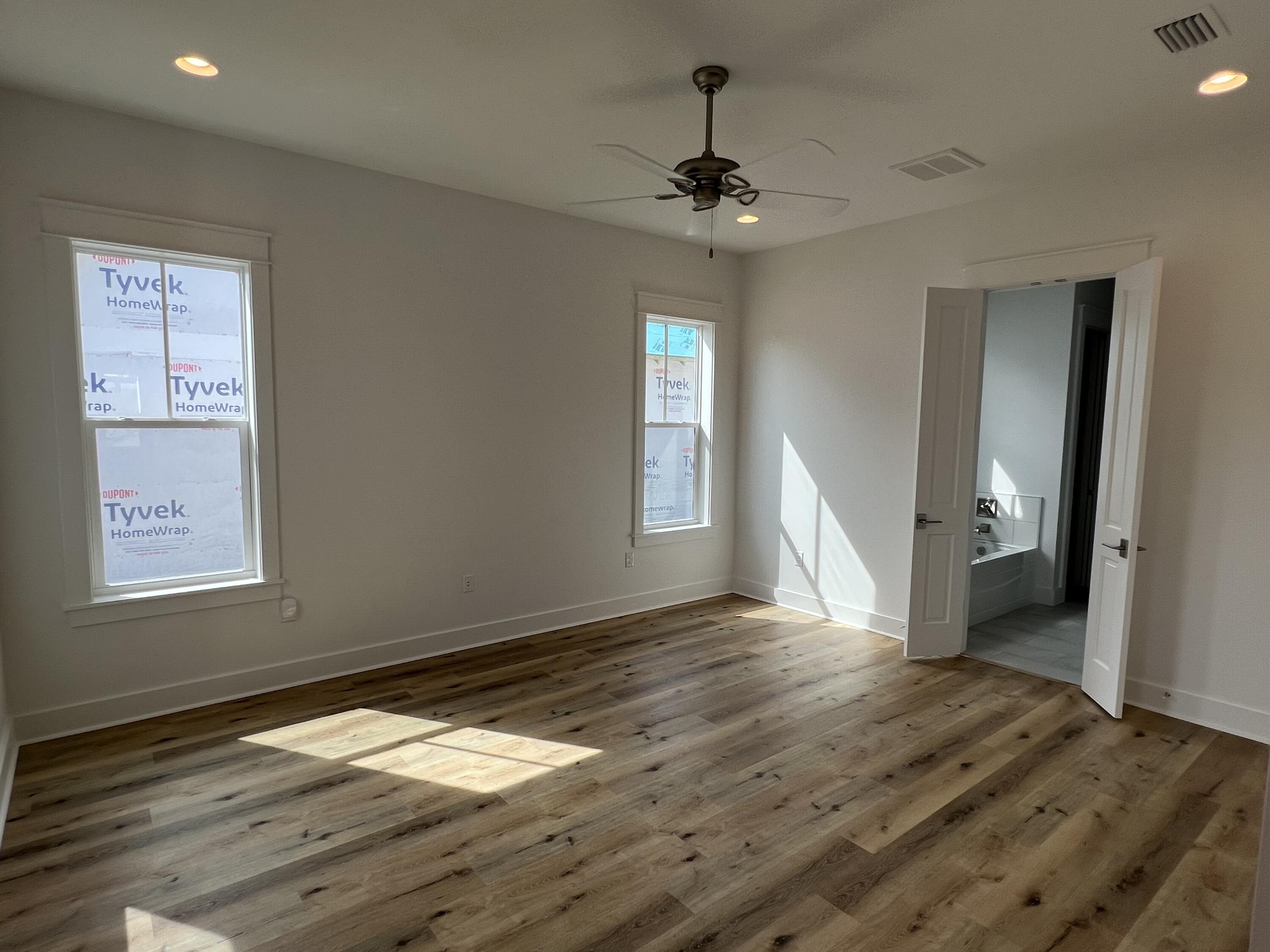 108 Sidecamp Road Watersound, FL 32461 - Photo 11 of 36 a view of empty room with wooden floor and fan