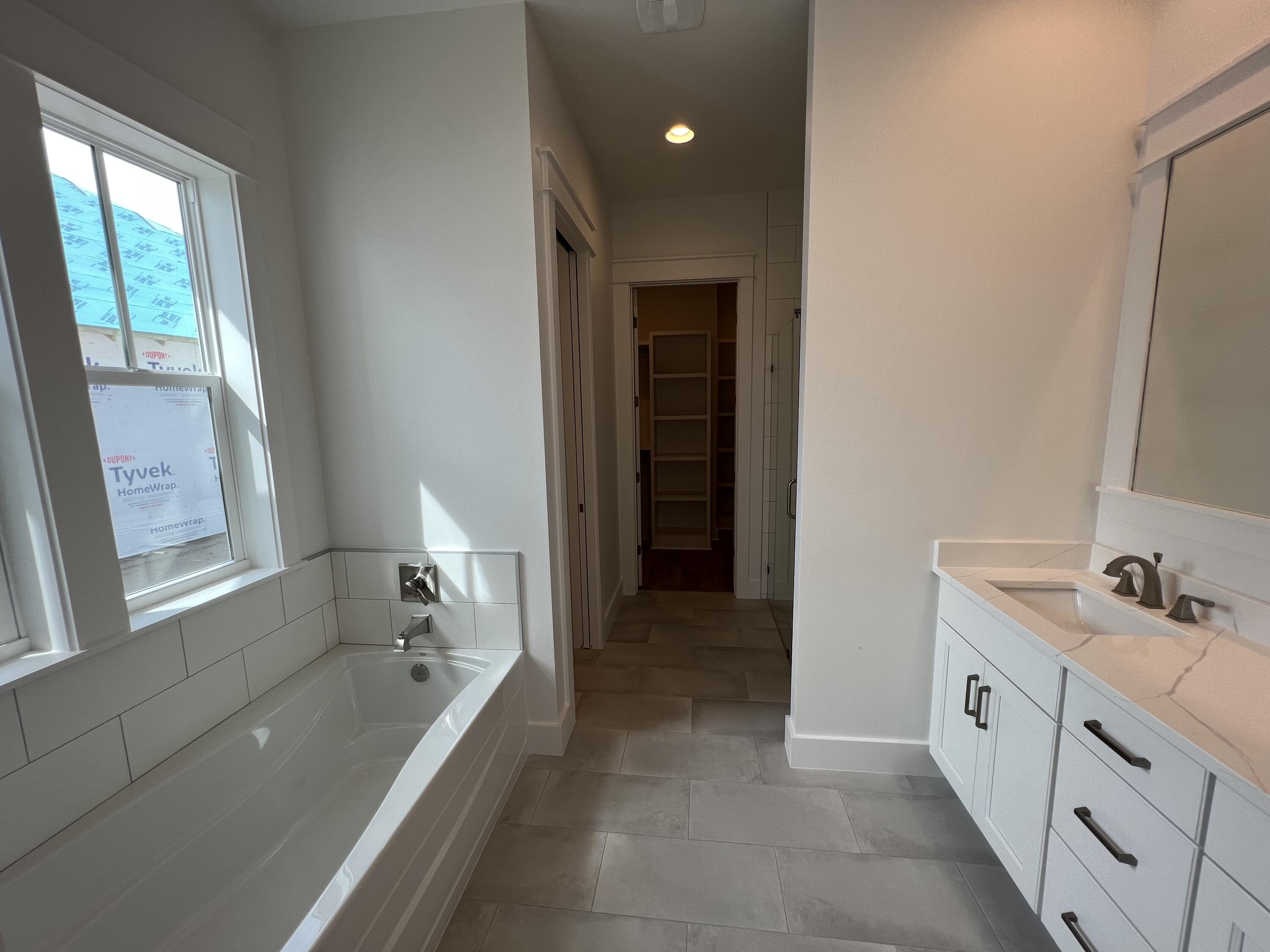 108 Sidecamp Road Watersound, FL 32461 - Photo 13 of 36 a bathroom with a bathtub sink and mirror