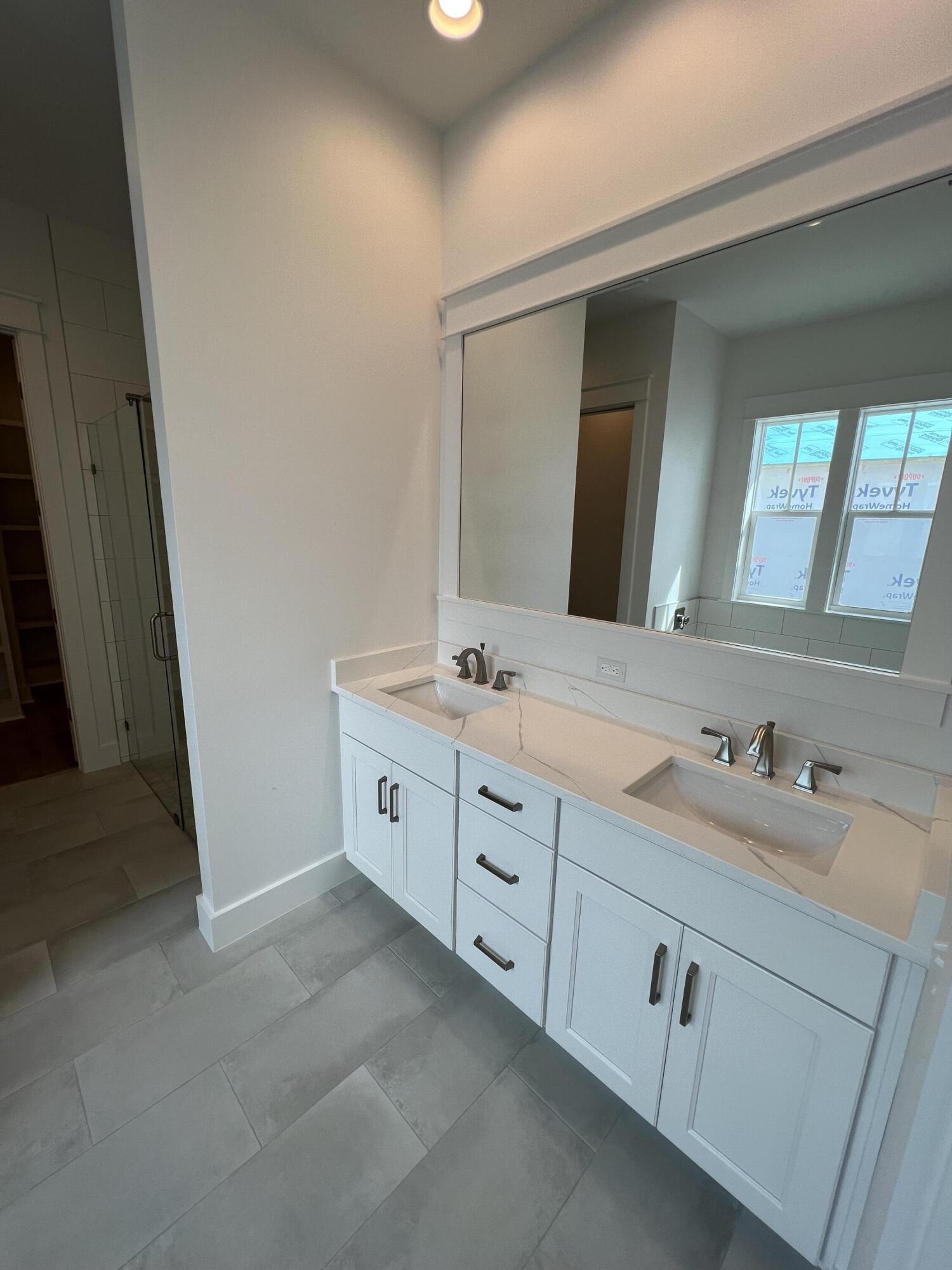 108 Sidecamp Road Watersound, FL 32461 - Photo 14 of 36 a spacious bathroom with a double vanity sink and mirror