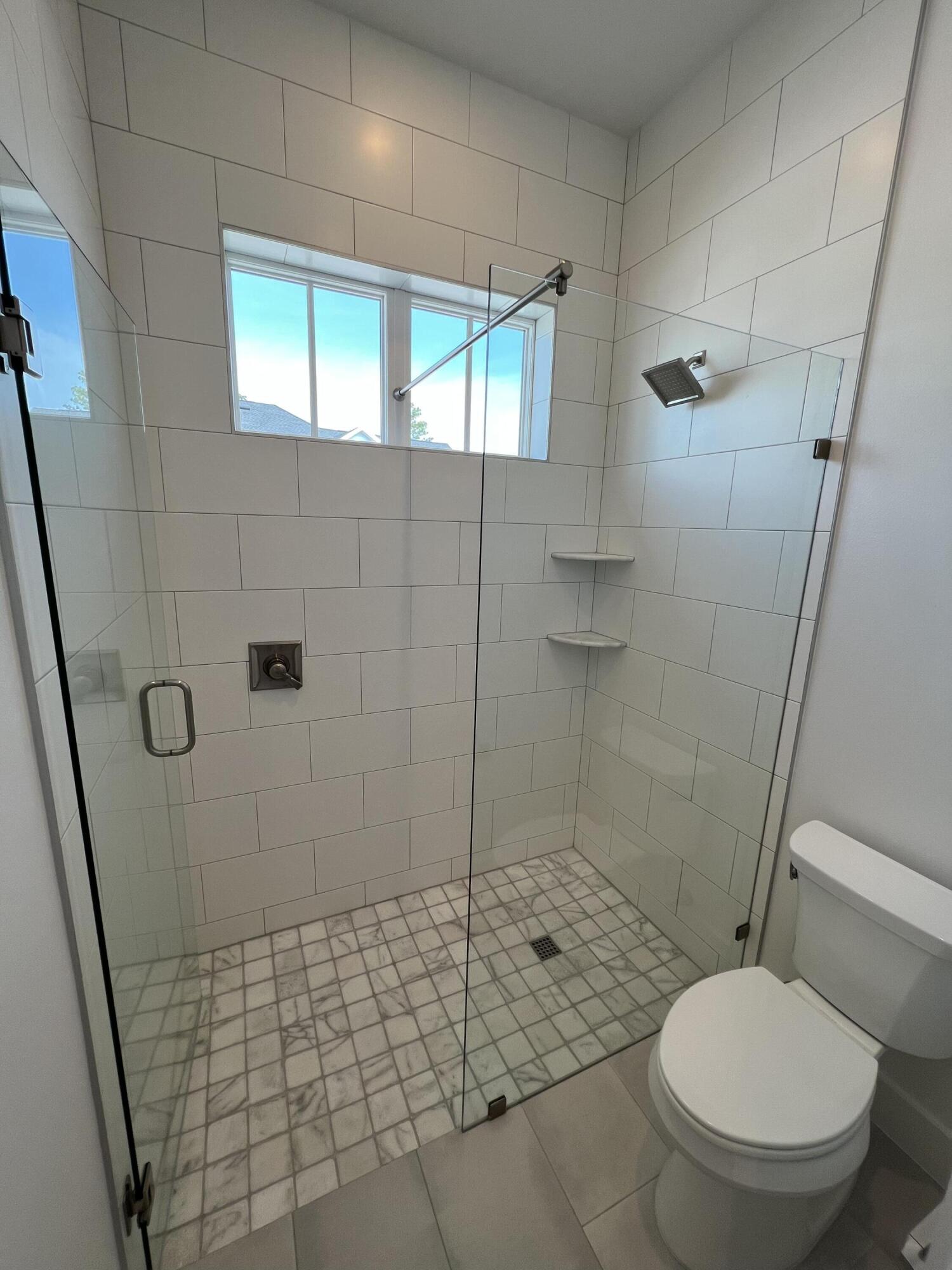 108 Sidecamp Road Watersound, FL 32461 - Photo 21 of 36 a bathroom with a toilet and a shower