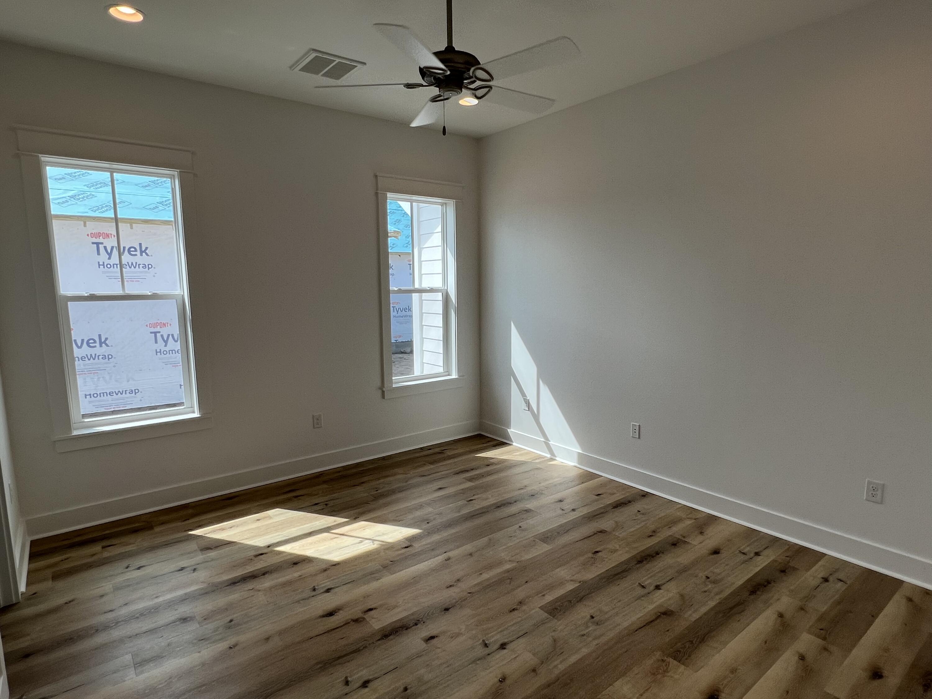 108 Sidecamp Road Watersound, FL 32461 - Photo 22 of 36 a view of empty room with wooden floor and fan
