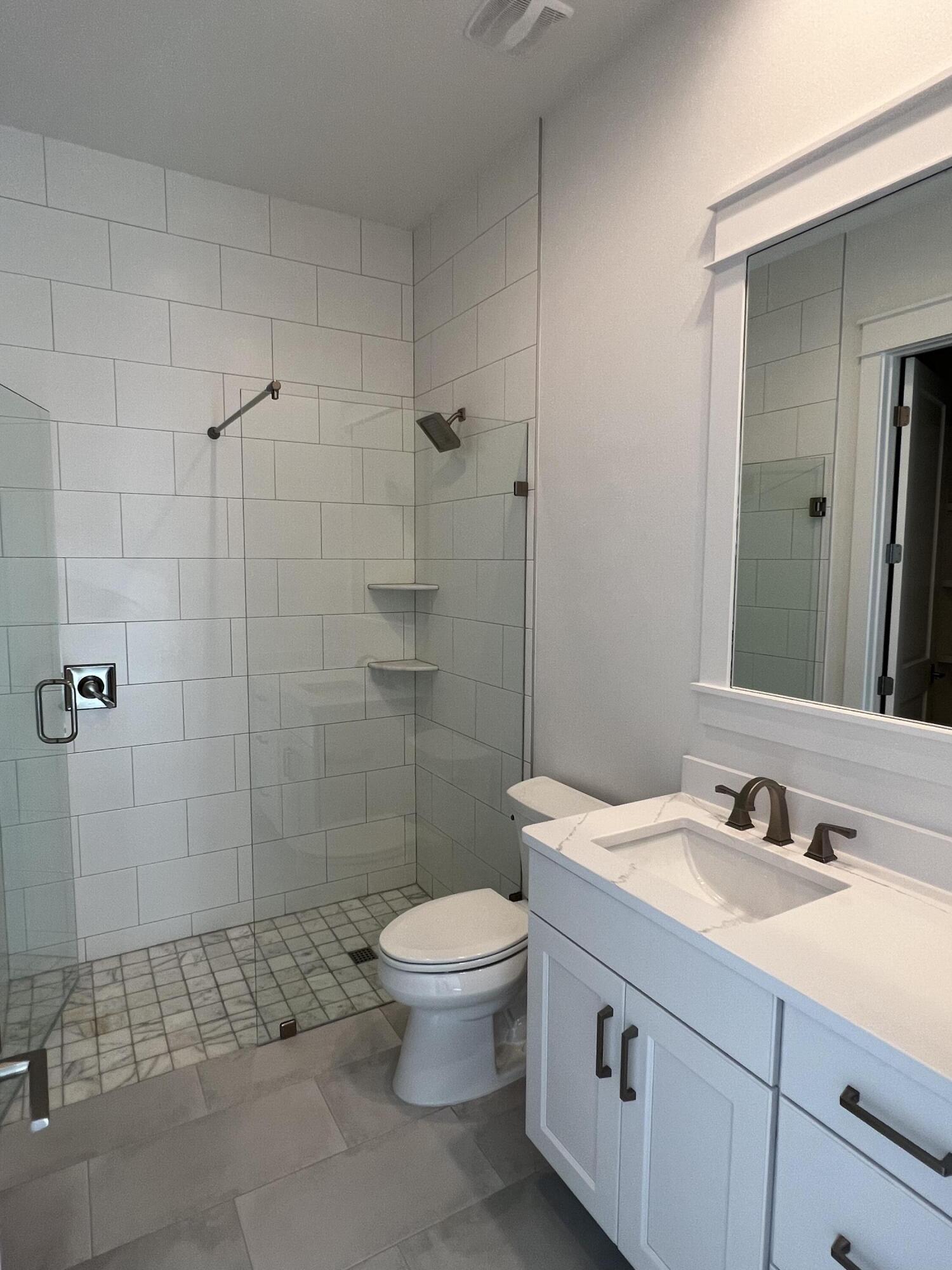 108 Sidecamp Road Watersound, FL 32461 - Photo 23 of 36 a bathroom with a sink a toilet and shower