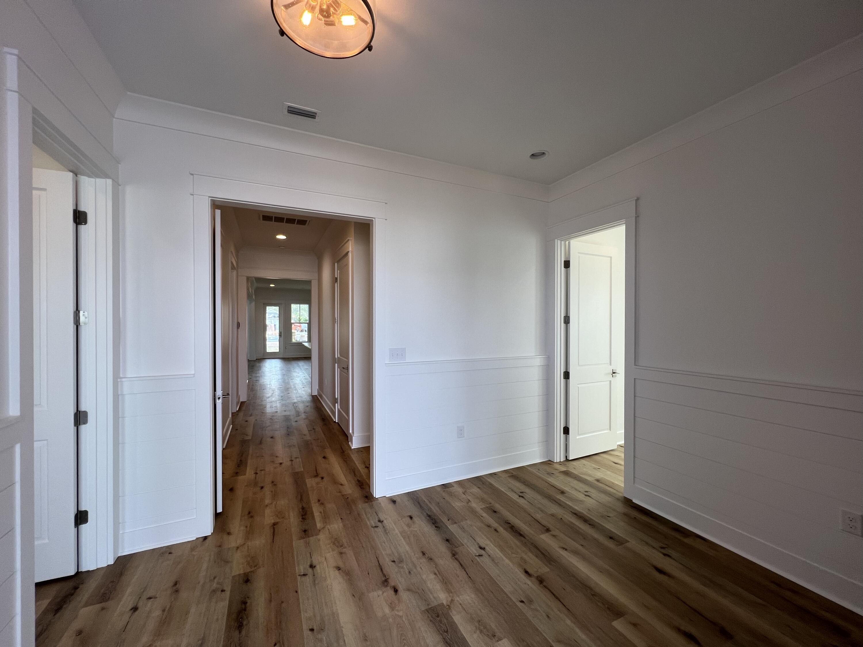 108 Sidecamp Road Watersound, FL 32461 - Photo 3 of 36 a view of an empty room with wooden floor and closet