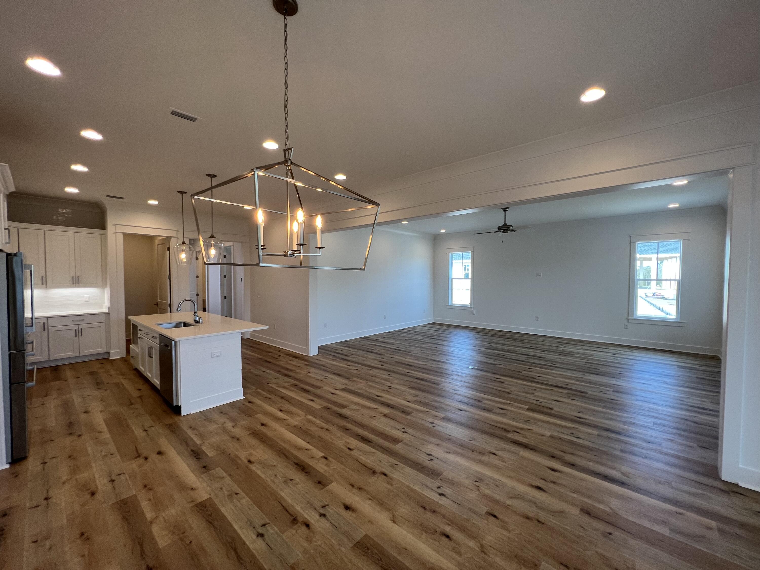 108 Sidecamp Road Watersound, FL 32461 - Photo 4 of 36 a view of a room with kitchen island microwave and wooden floor