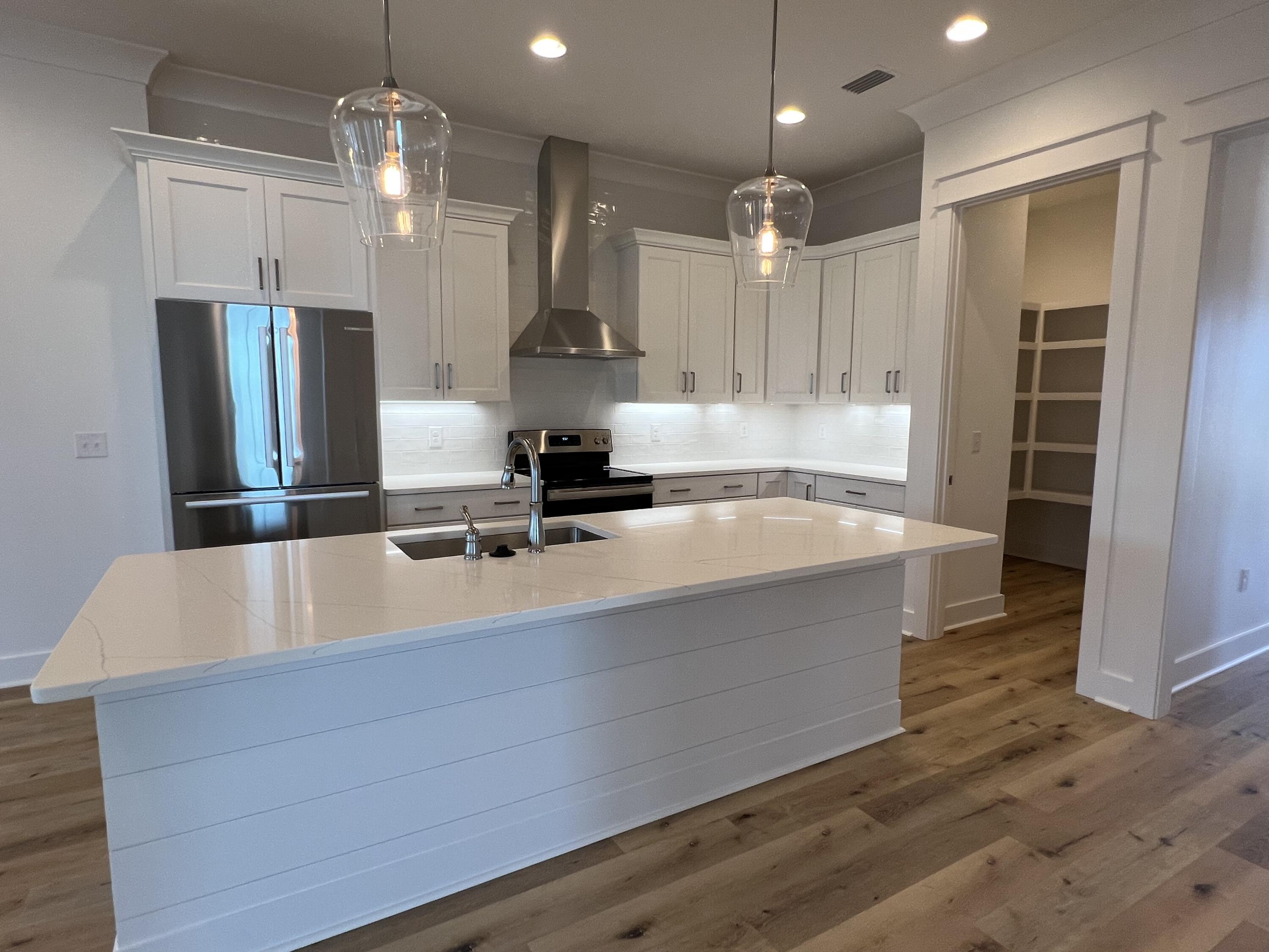 108 Sidecamp Road Watersound, FL 32461 - Photo 5 of 36 a large kitchen with kitchen island a counter space a sink stainless steel appliances and cabinets
