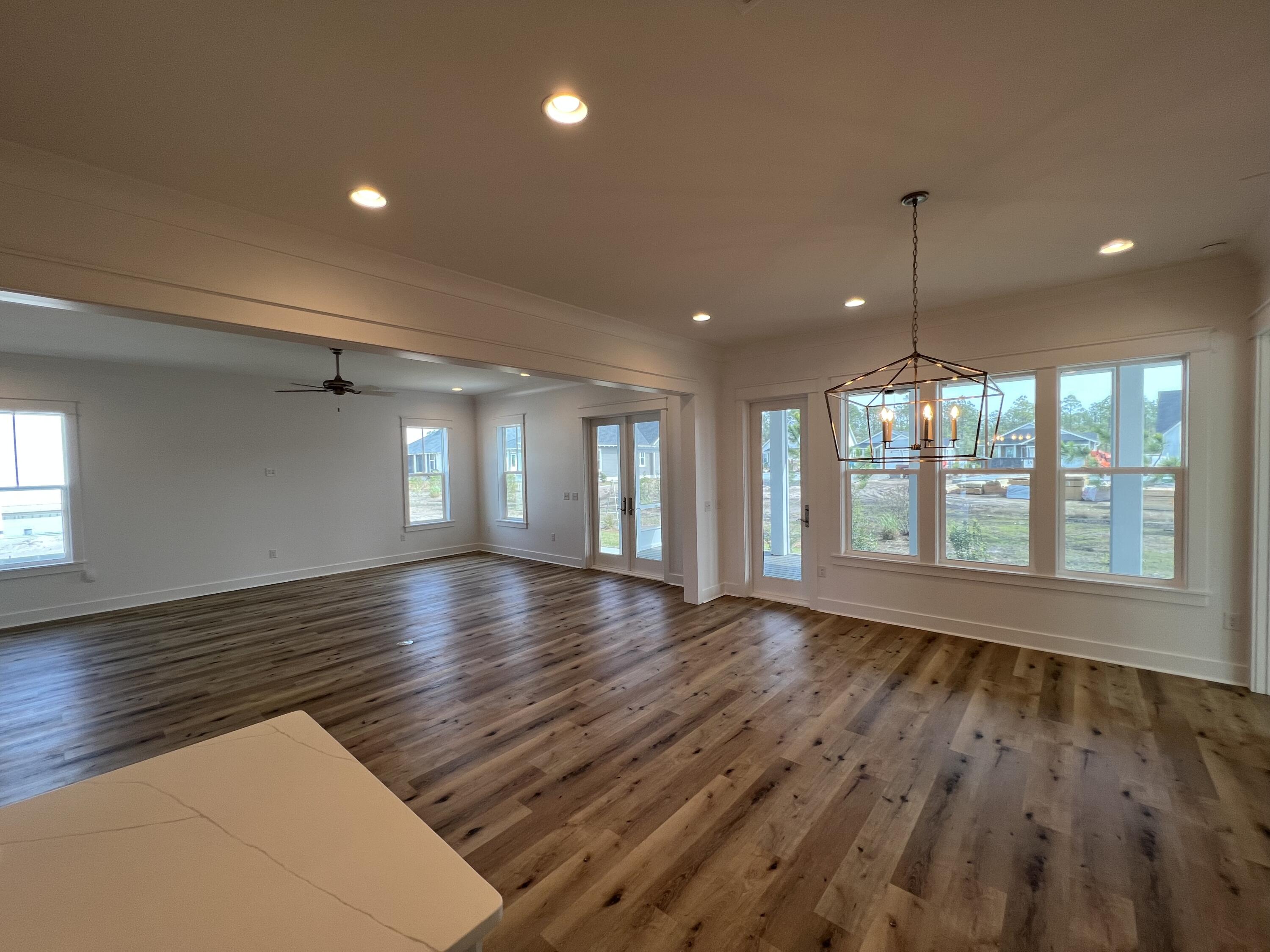 108 Sidecamp Road Watersound, FL 32461 - Photo 8 of 36 an empty room with wooden floor and windows