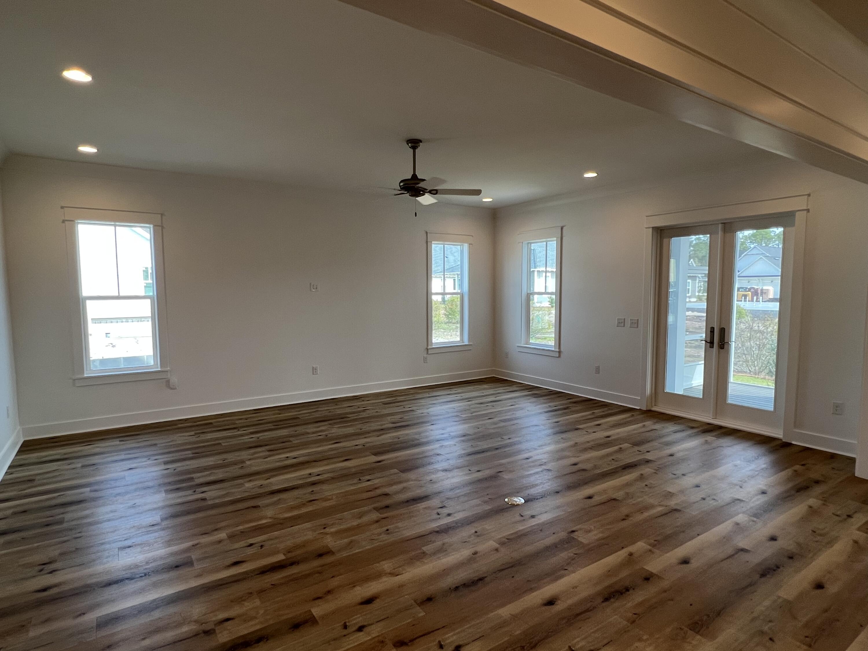 108 Sidecamp Road Watersound, FL 32461 - Photo 9 of 36 an empty room with wooden floor and windows