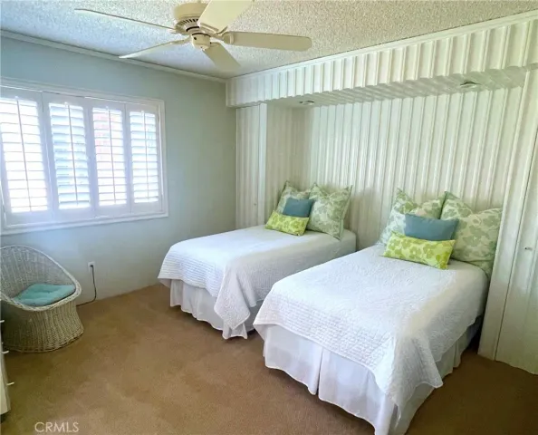 a bedroom with two beds and a window