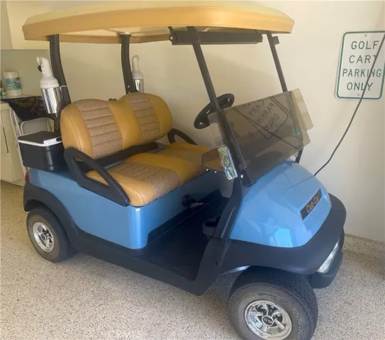 a blue bed sitting in a room next to a lamp