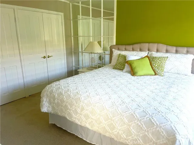 a bed sitting in a bedroom next to a bathroom