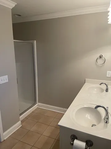 a bathroom with a double vanity sink toilet mirror and bathtub