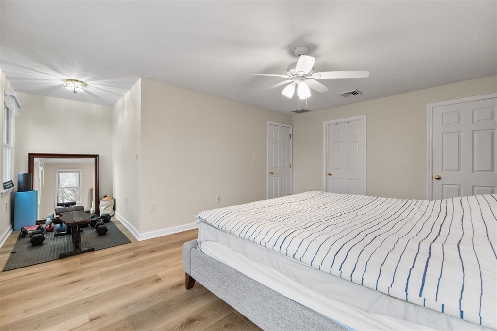 13 Plain Street Upton, MA 01568 - Photo 14 of 27 a bedroom with a bed and a chandelier