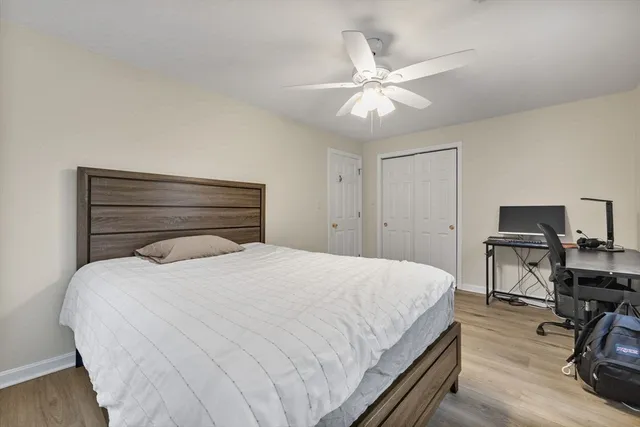 a bedroom with a bed and a chandelier